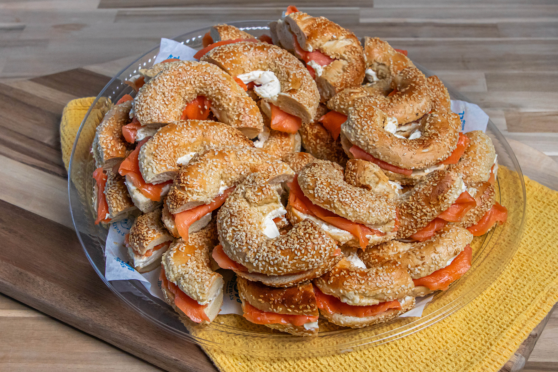 Catering platter of bagels spread with cream cheese and smoked salmon.