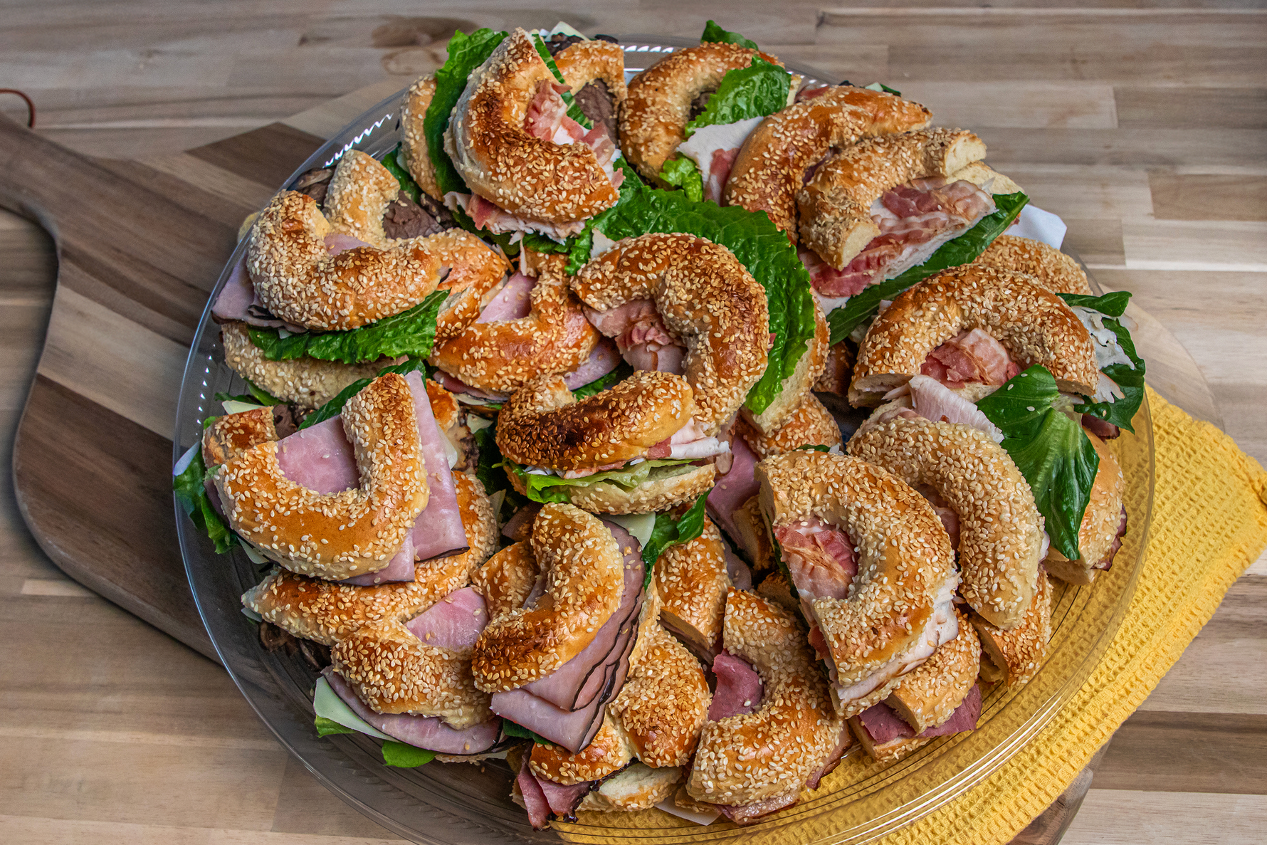 Catering platter of assorted bagel sandwiches.