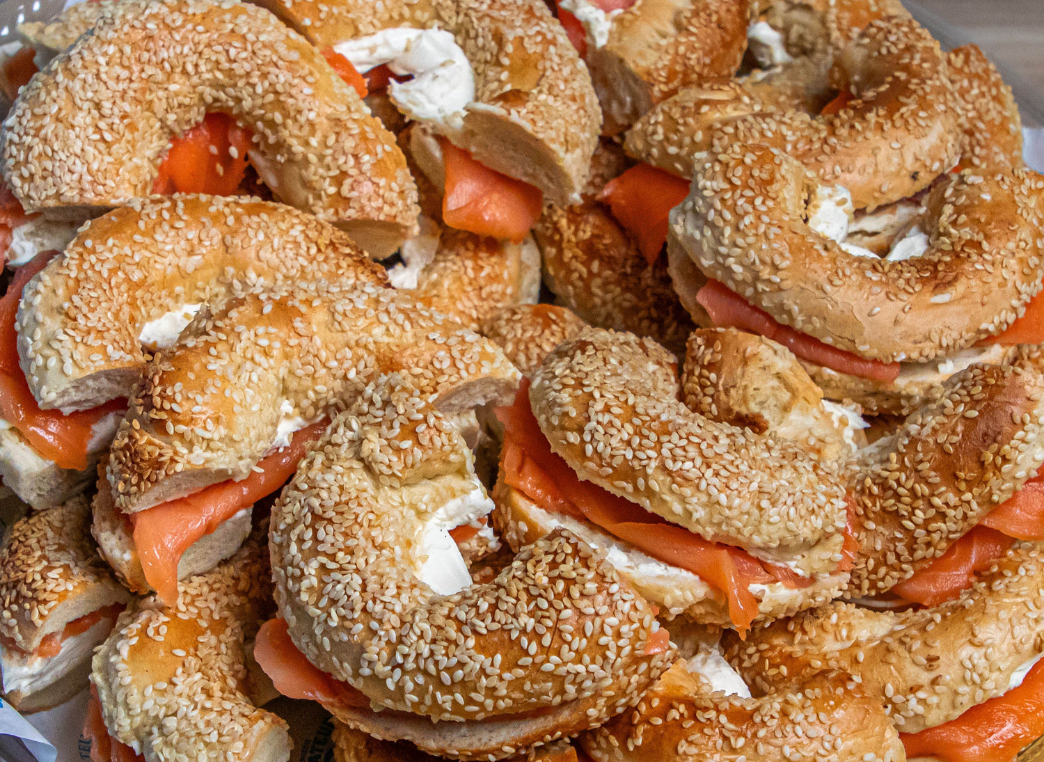 Close up of fresh bagels with cream cheese and smoked salmon.