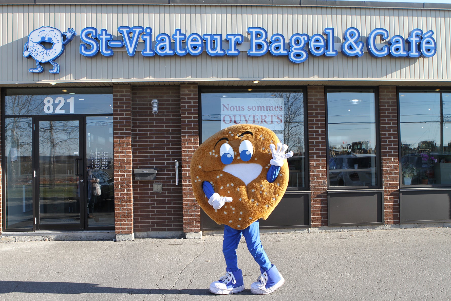 Sesame the bagel mascot outside of a St-Viateur bagel and cafe location